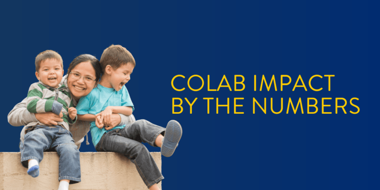 woman smiling and holding her laughing little boys